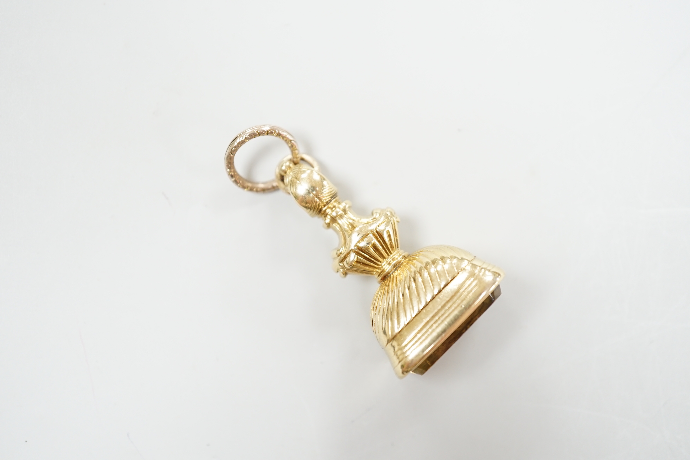 An early 19th century gold overlaid fob seal, the matrix carved with a boars head crest and motto, height 4cm